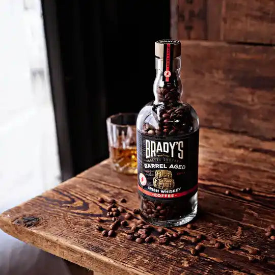 Whole bean, barrel-aged coffee, in a glass whiskey bottle